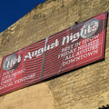 Full-colour vinyl campaign banner with grommets, mounted outdoors