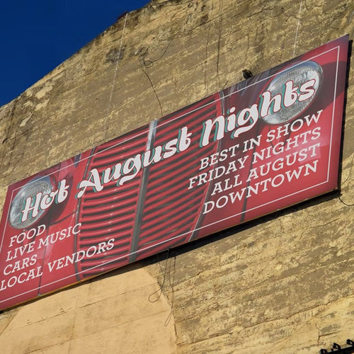 Full-colour vinyl campaign banner with grommets, mounted outdoors
